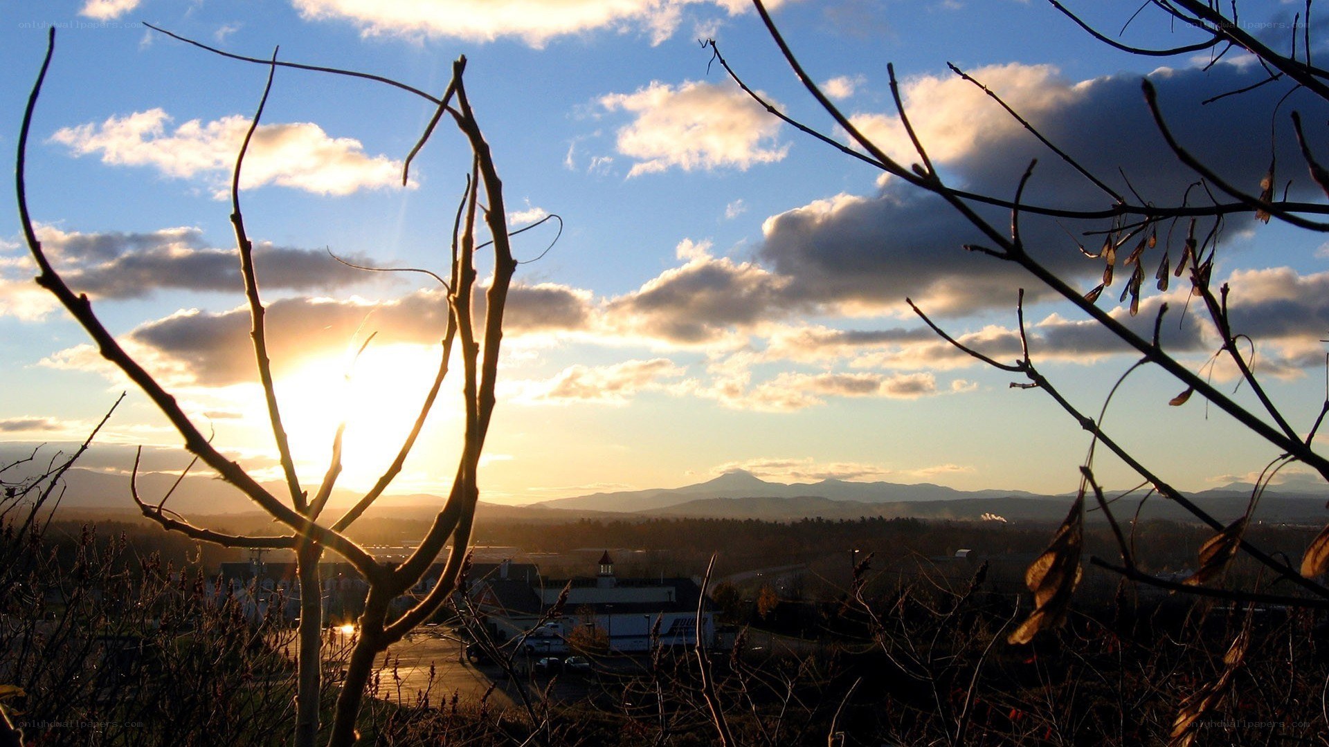 Sunset over a town with mountains
