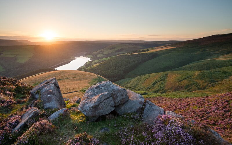 Sunset over a valley with a lake