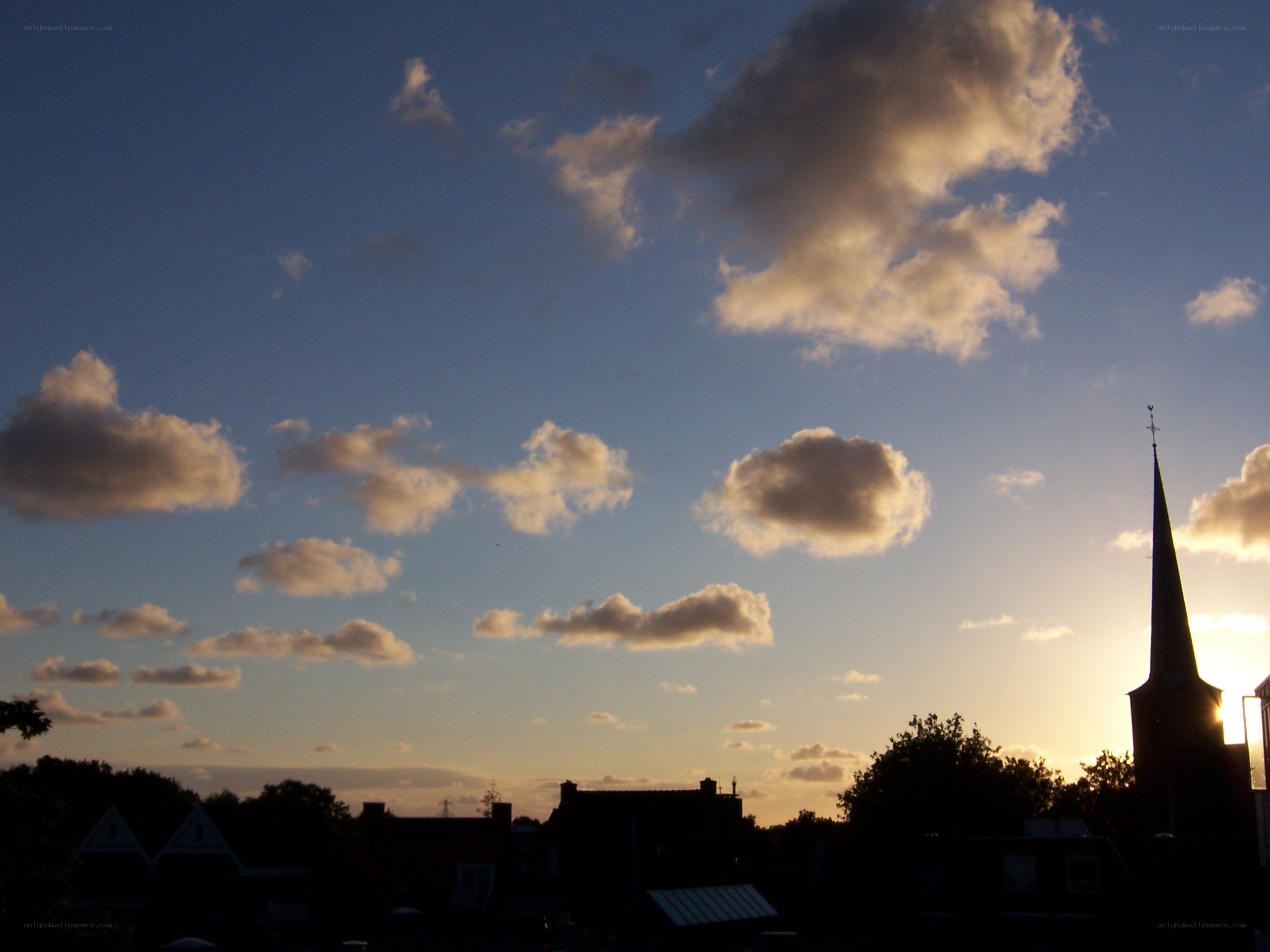 sunset over a village skyline