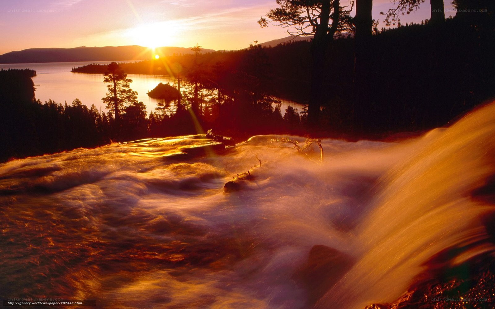 Sunset over a waterfall and lake