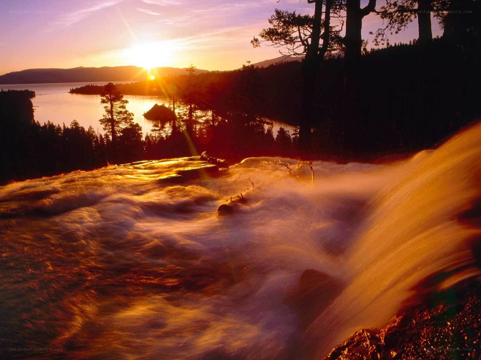 Sunset over a waterfall and lake