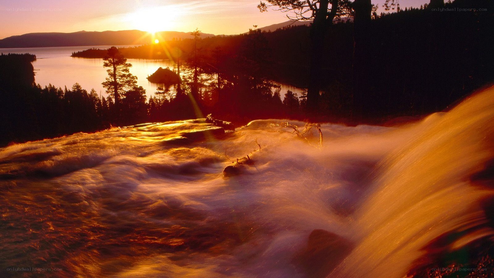 Sunset over a waterfall and lake