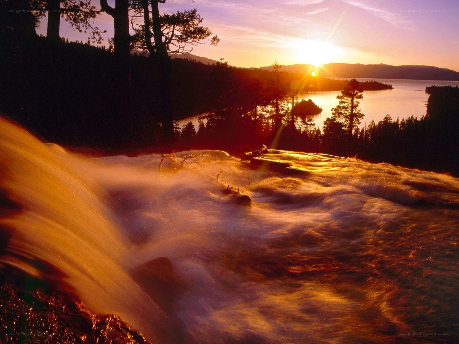 Sunset over a waterfall and lake
