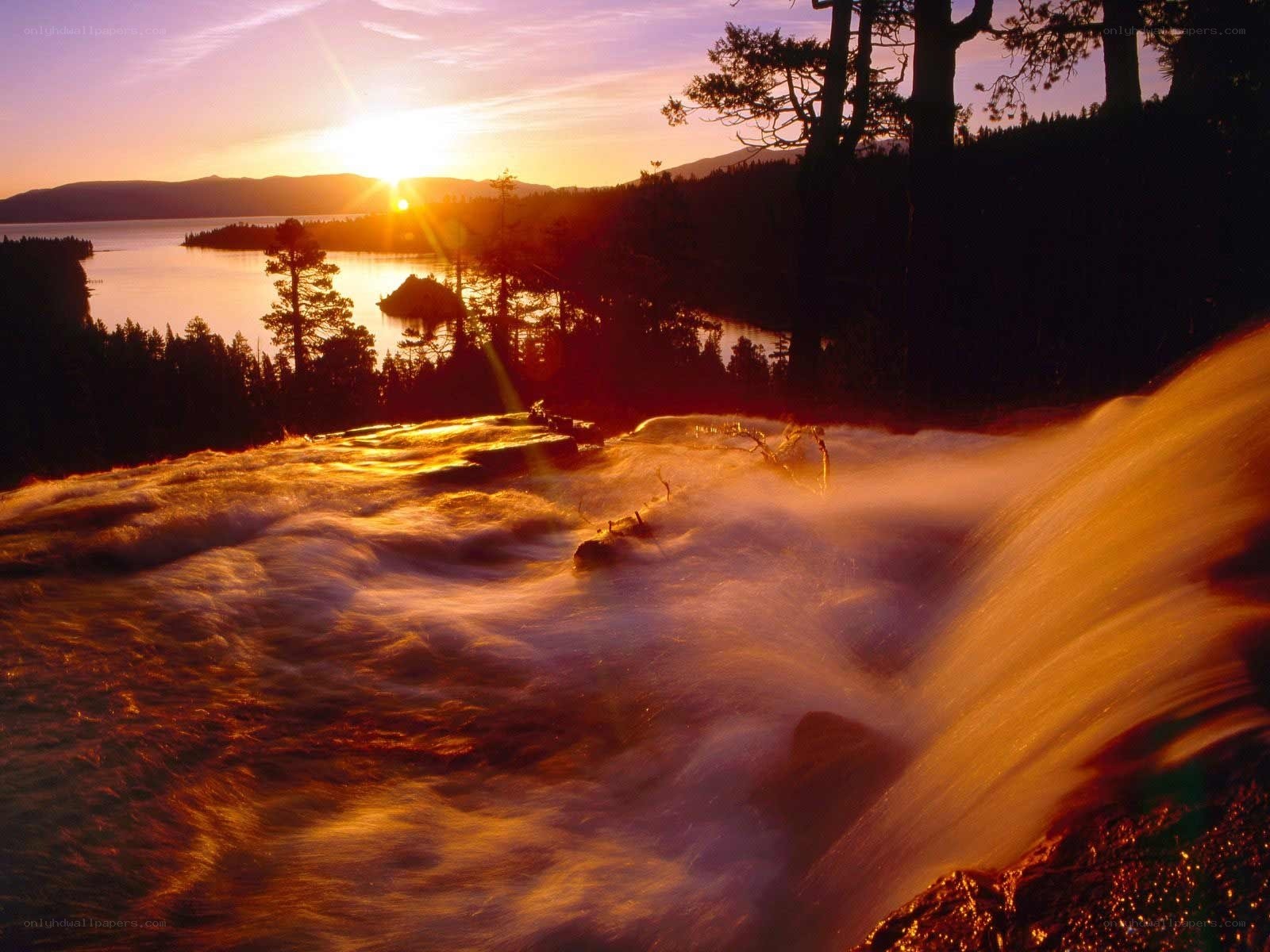 Sunset over a waterfall and lake