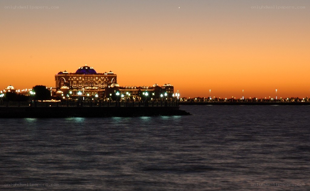 sunset over a waterfront palace