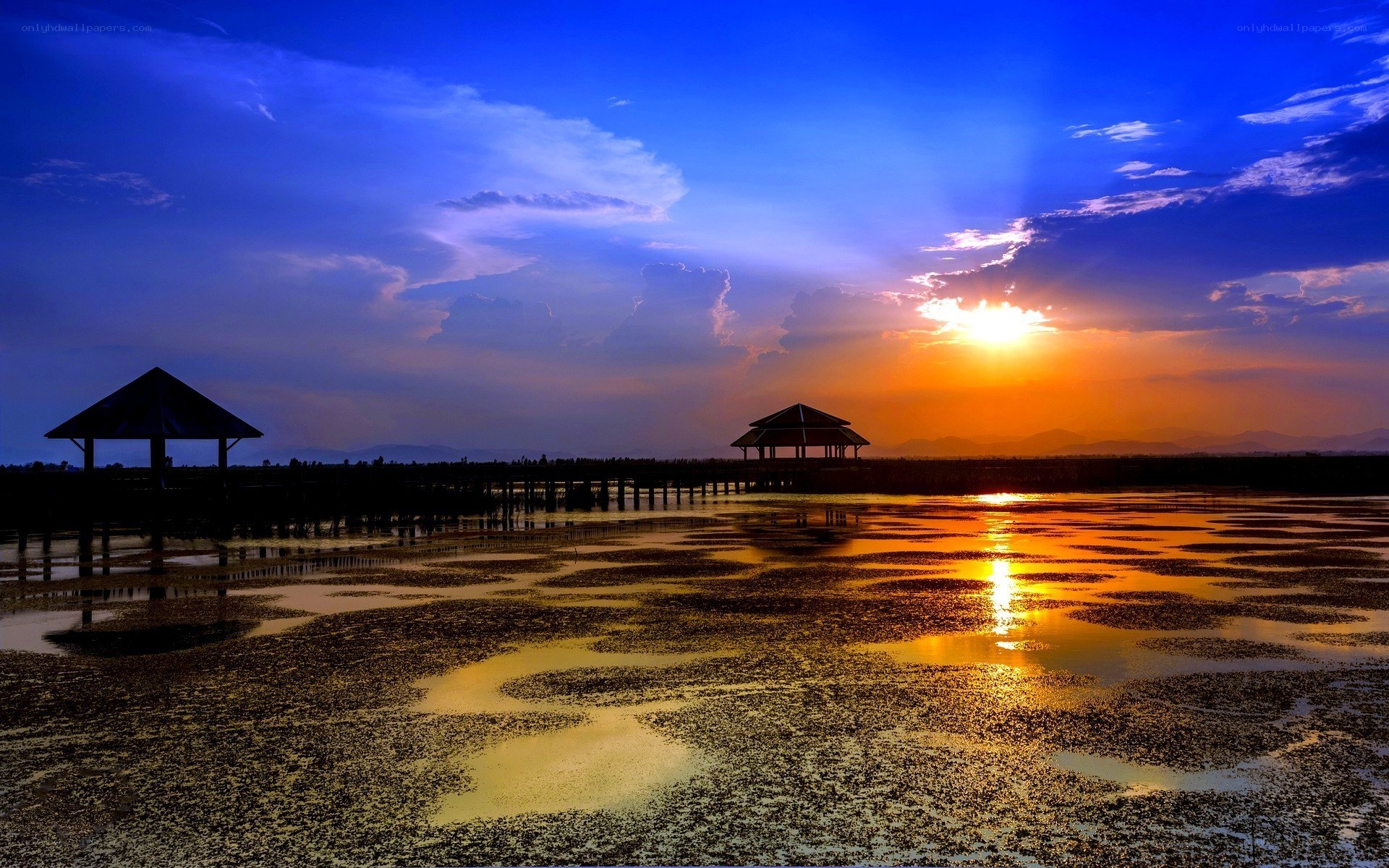 Sunset over a wetland with pavilions