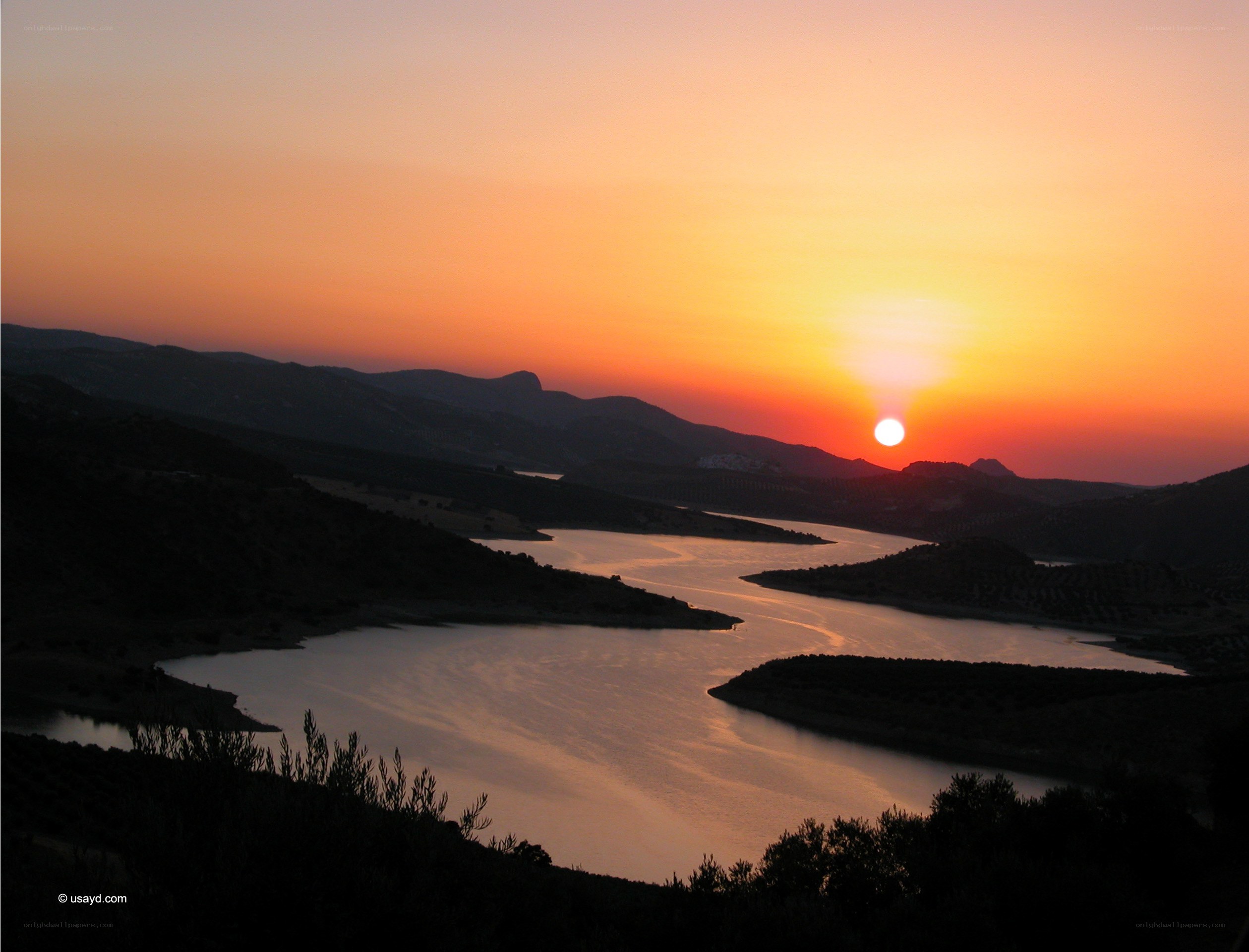 sunset over a winding river