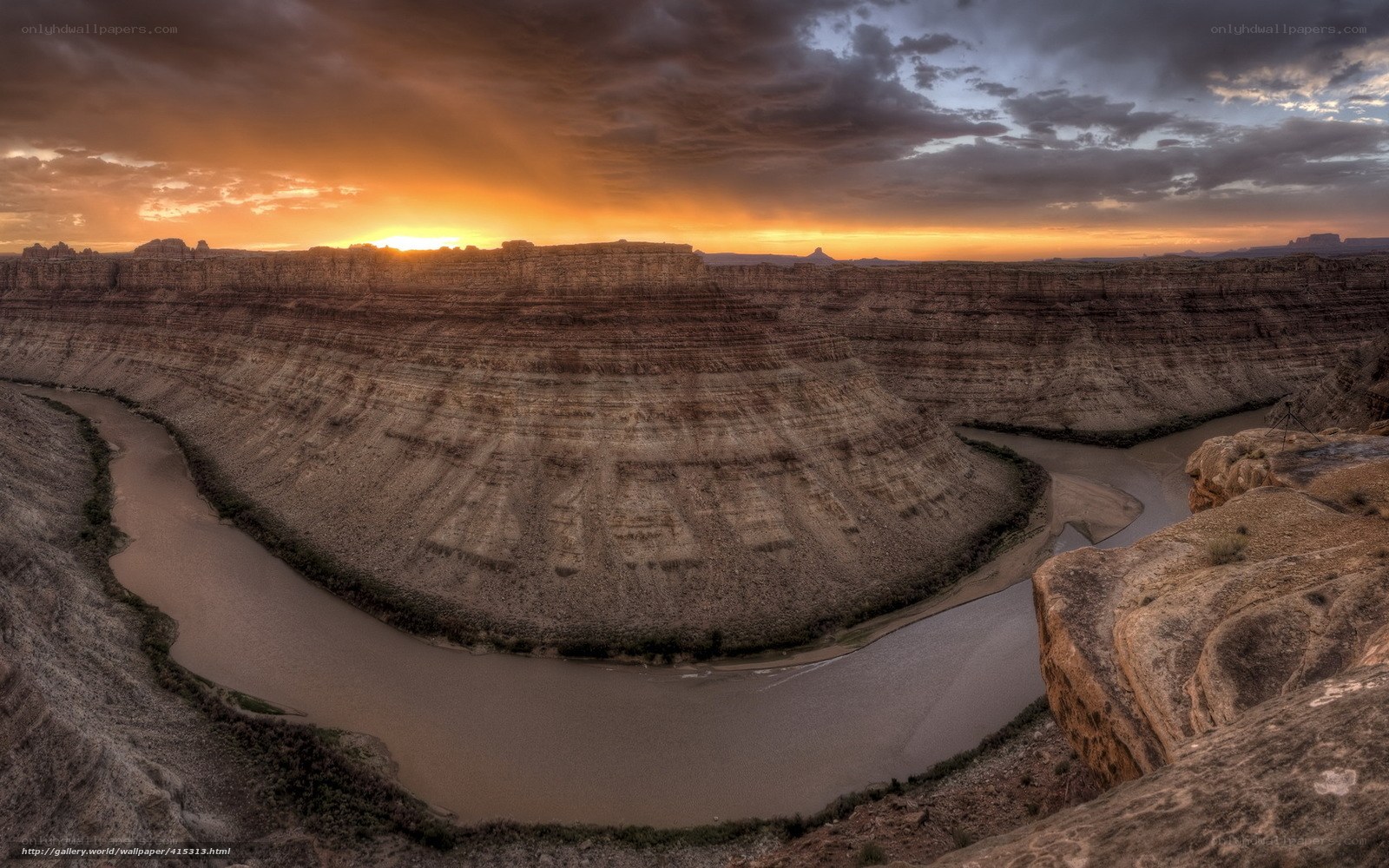 Sunset over a winding river canyon