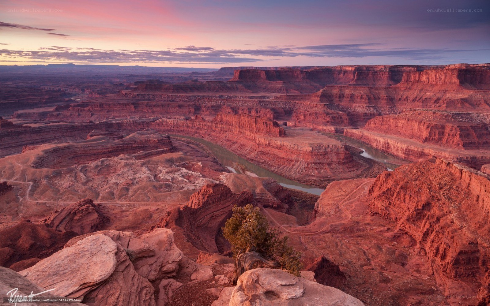 Sunset over a winding river canyon