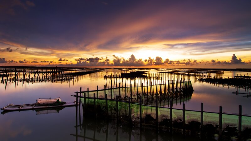 Sunset over aquaculture farm