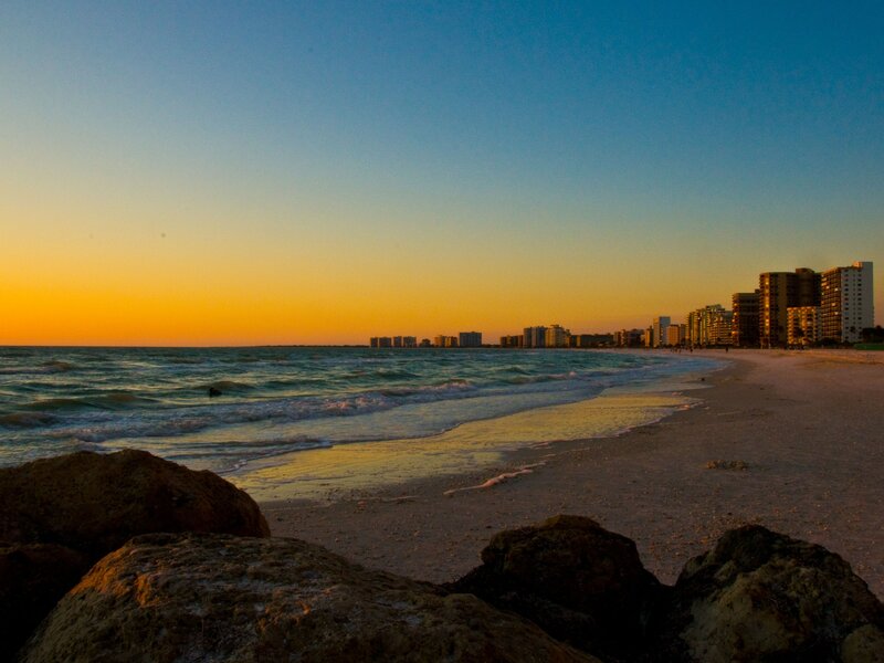 sunset over beach cityscape