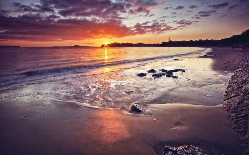 Sunset over Beach — Orange, Serene, Photograph, Ocean, Rocks, Clouds, Purple