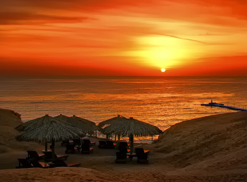 Sunset over Beach — Orange, Serene, Photograph, Umbrellas