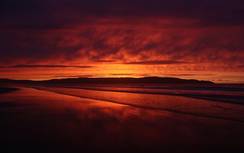 Sunset over Beach — Red, Dramatic, Photograph, Ocean, Sky, Mountains
