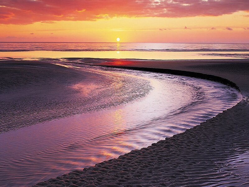 Sunset over beach stream