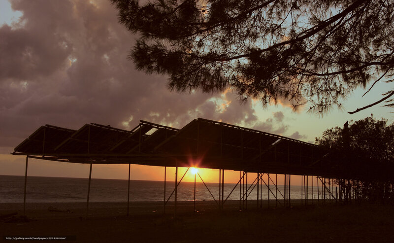 sunset over beach structure