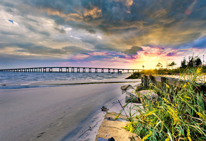 Sunset over beach with bridge