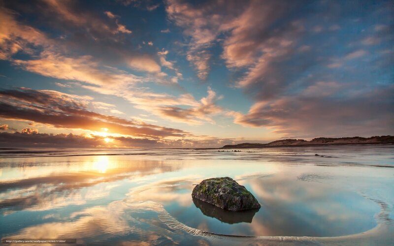 Sunset over beach with rock