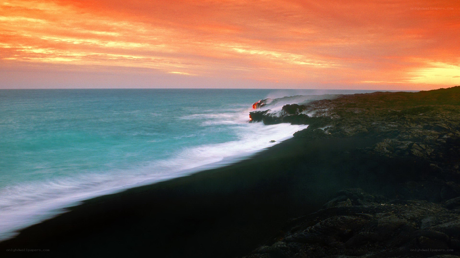 sunset over black sand beach