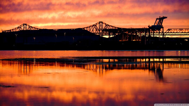 sunset over bridge and water