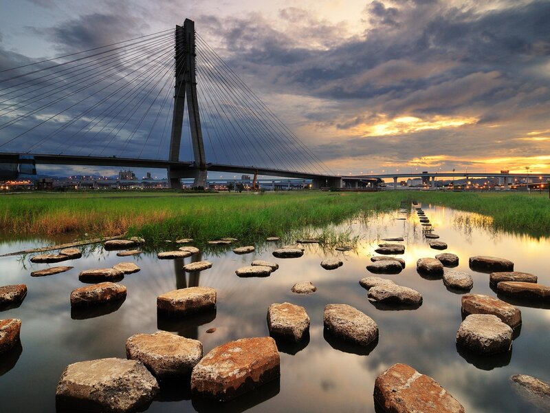 Sunset over Cable-stayed Bridge — Blue, Serene, Photograph, River, Grass