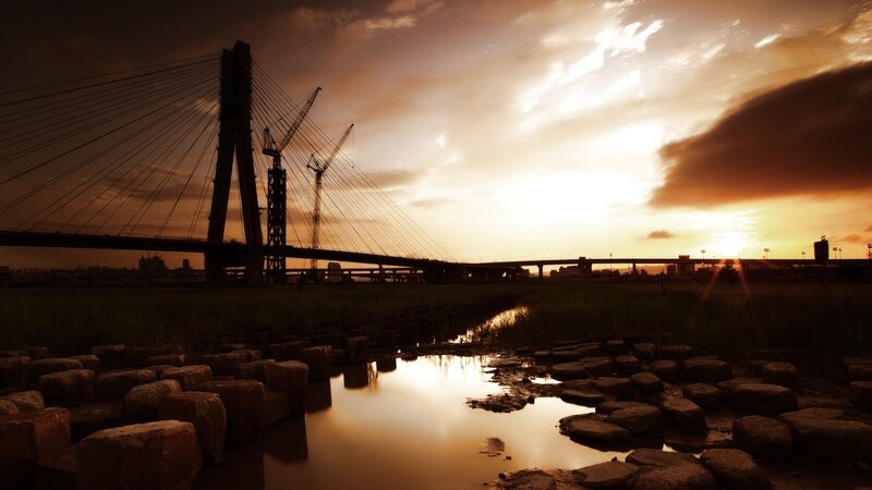 Sunset over Cable-stayed Bridge — Orange, Dramatic, Photograph, Cranes