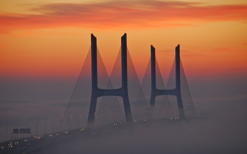 Sunset over Cable-stayed Bridge — Orange, Dramatic, Photograph, Sky, Fog