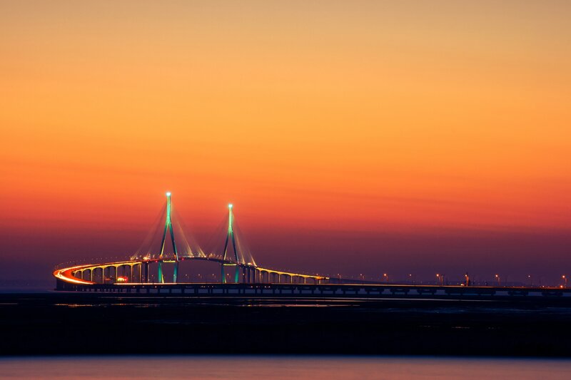 Sunset over Cable-stayed Bridge — Orange, Dramatic, Photograph, Sky, Water