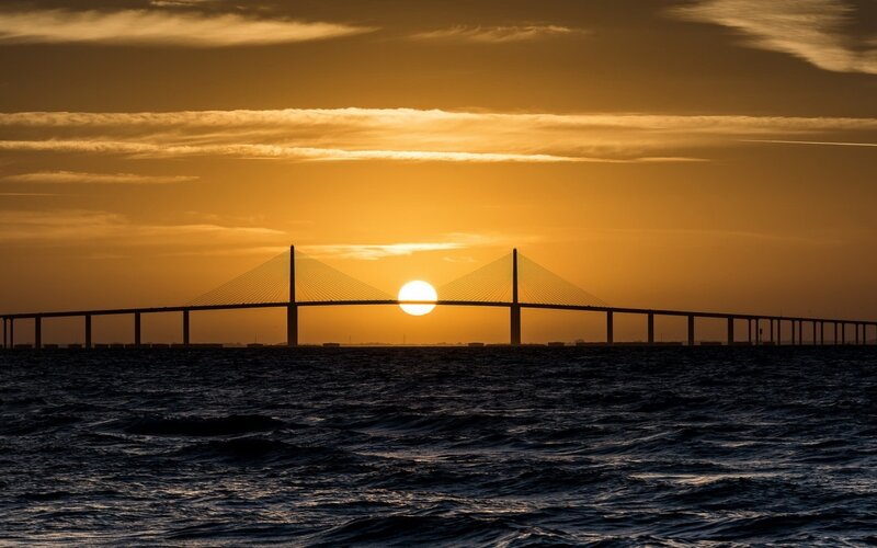 Sunset over Cable-stayed Bridge — Orange, Serene, Photograph, Sun, Sea