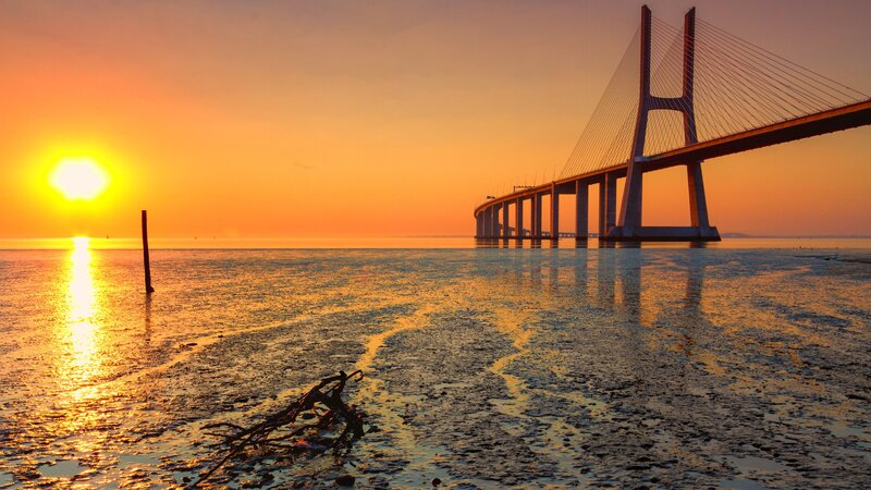 Sunset over Cable-stayed Bridge — Orange, Serene, Photograph, Sun