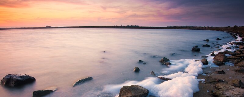 sunset over calm coastal waters