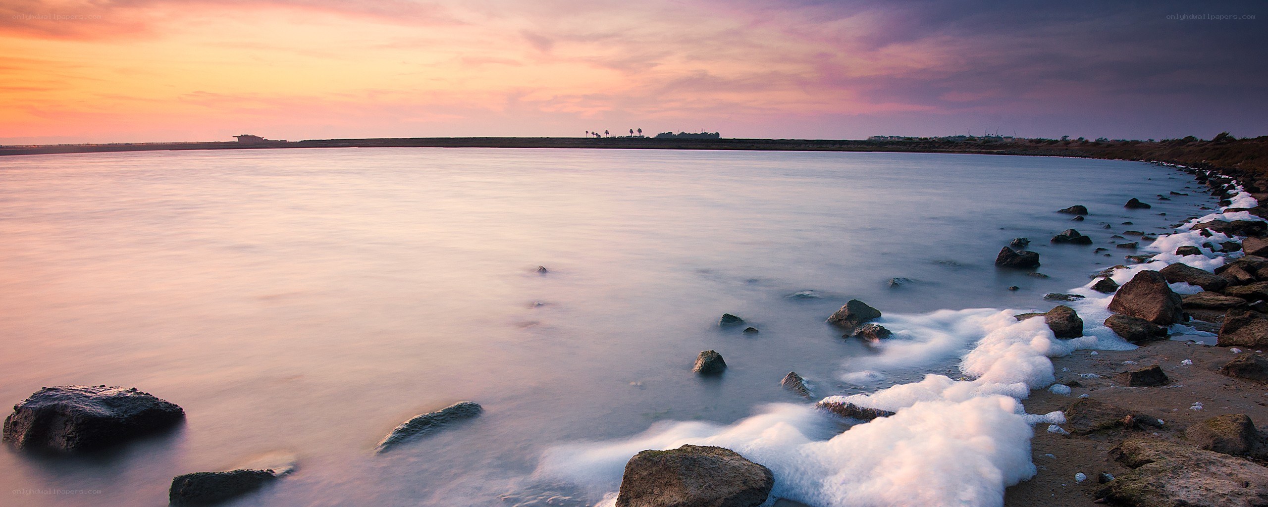 sunset over calm coastal waters
