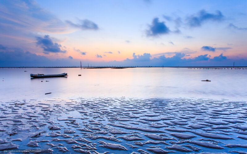 Sunset over calm coastal waters