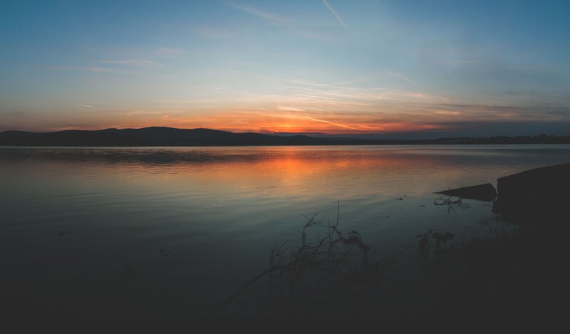 sunset over calm lake