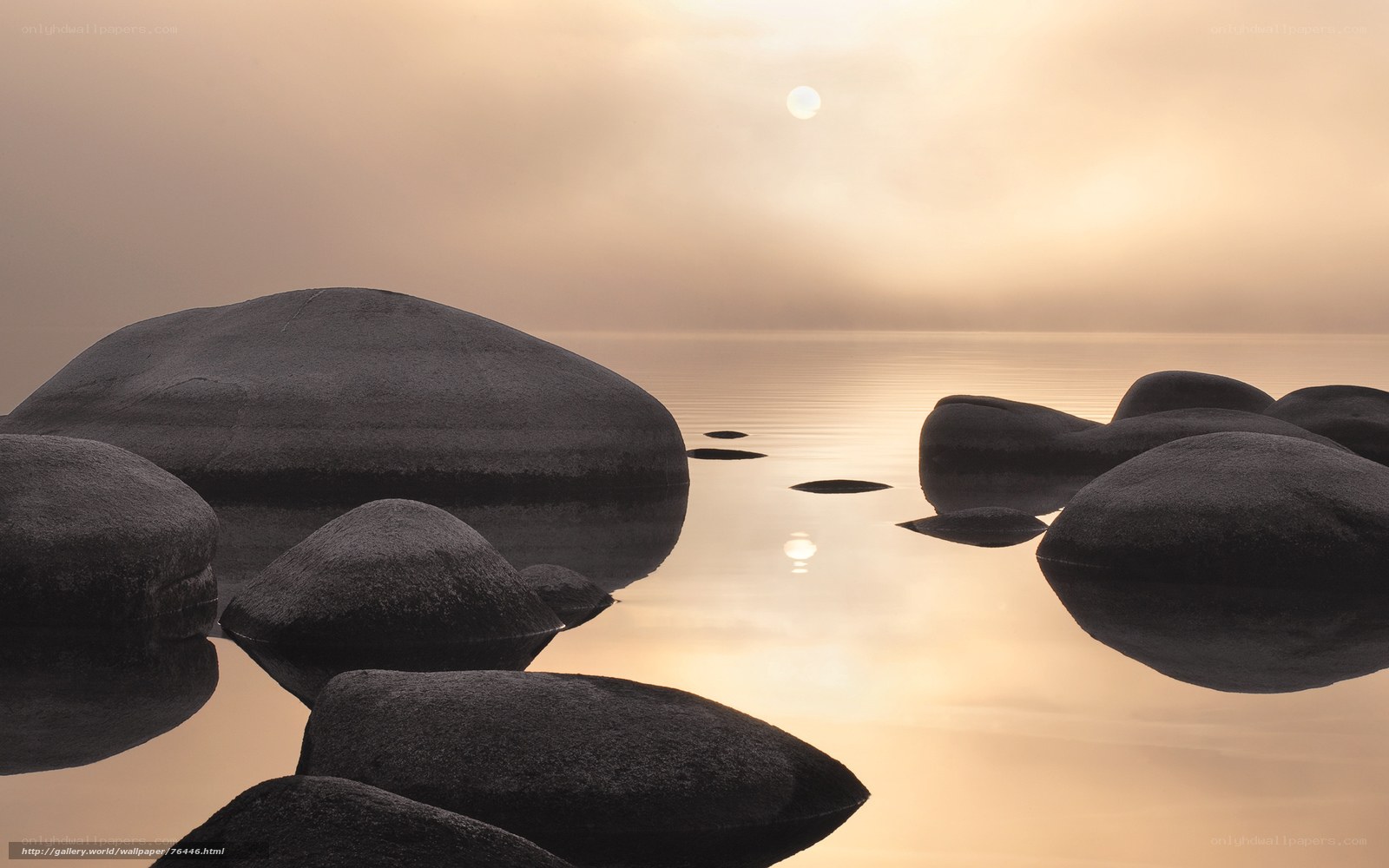 Sunset over calm lake with rocks