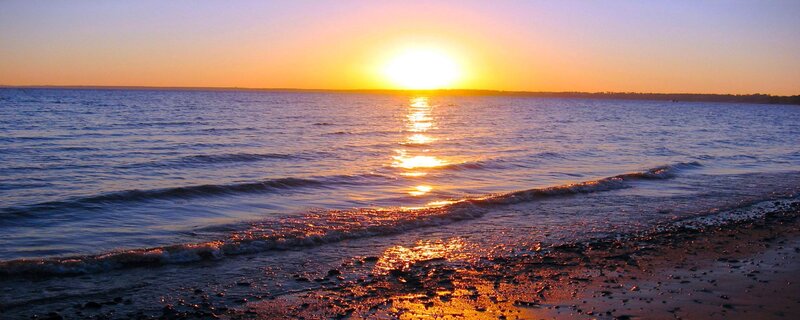 sunset over calm ocean