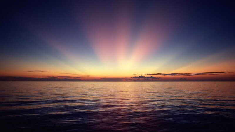 sunset over calm ocean