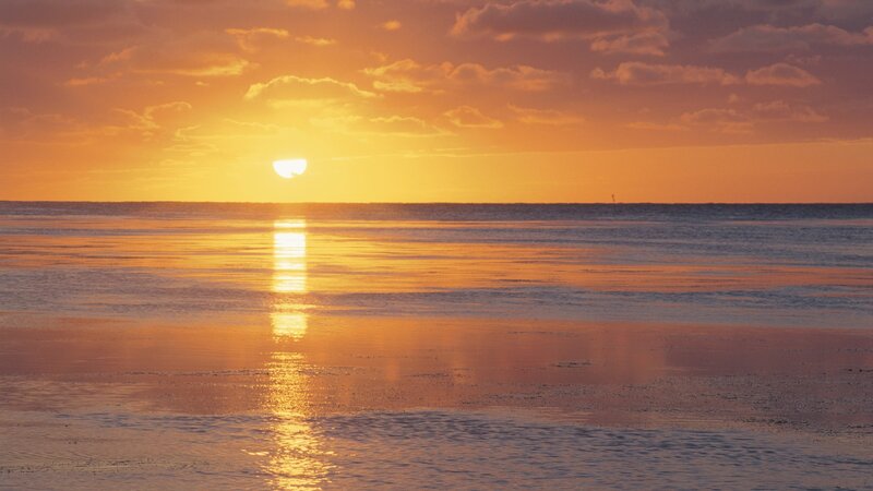 sunset over calm ocean