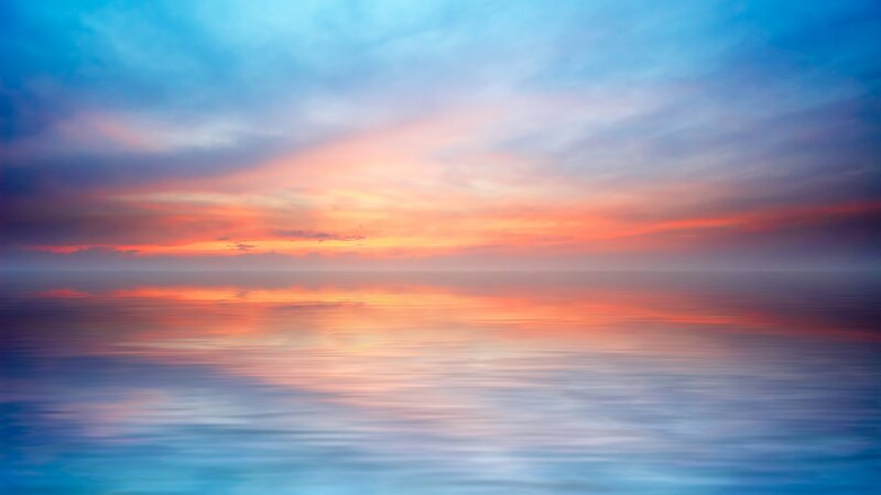 sunset over calm ocean