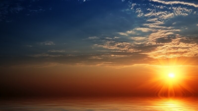 sunset over calm ocean