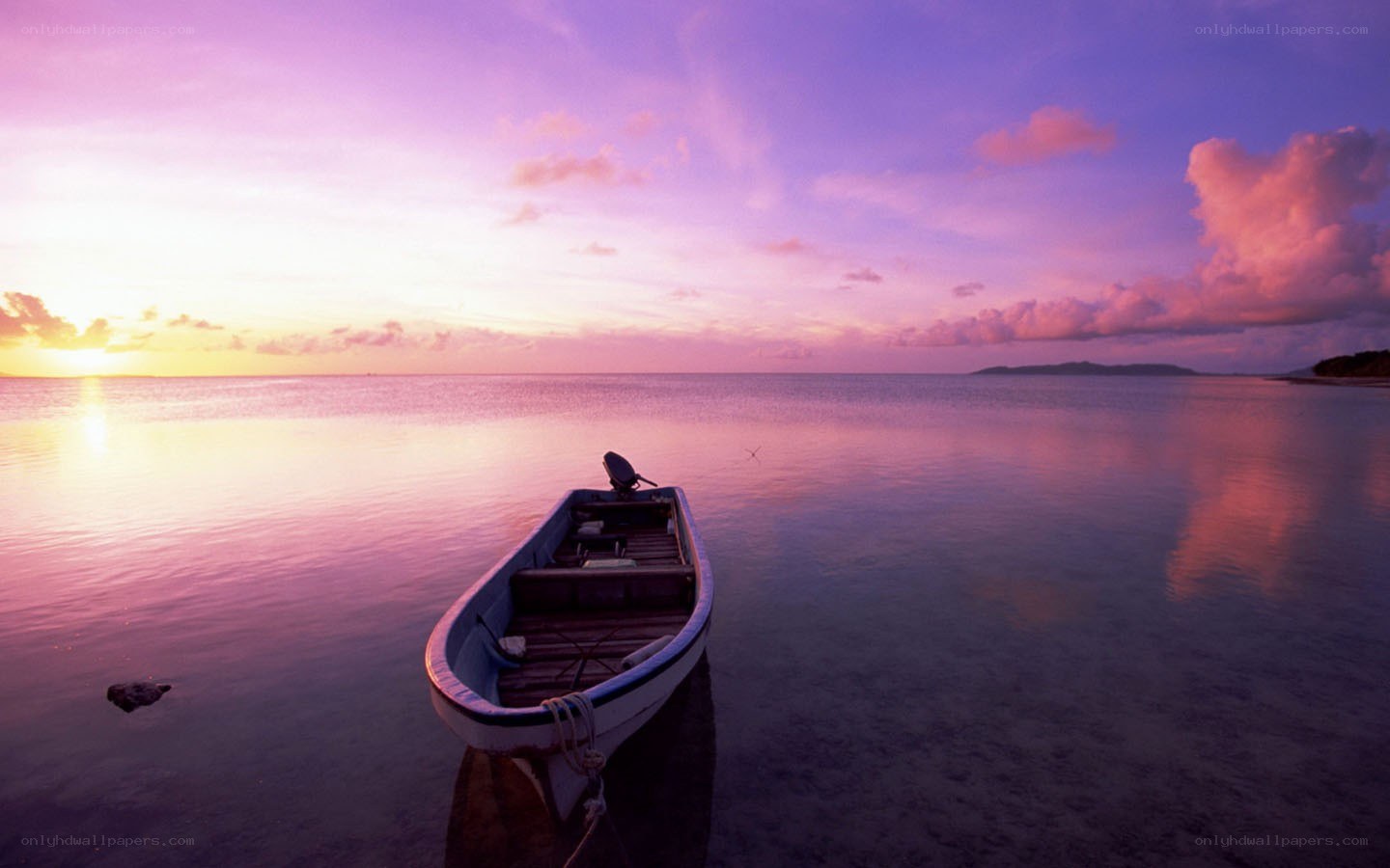 Sunset over calm sea with boat
