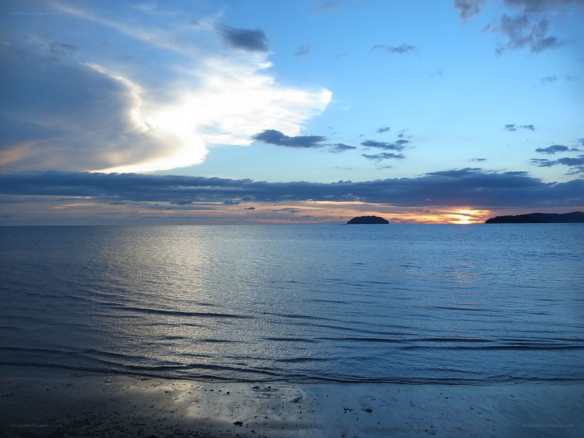 Sunset over calm sea with islands