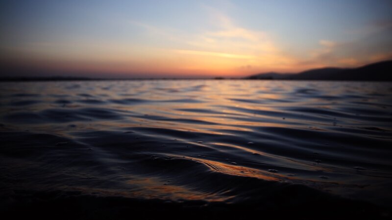 sunset over calm water