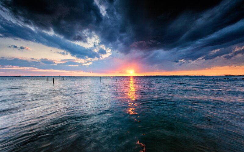 Sunset over Calm Water — Blue, Dramatic, Photograph, Clouds, Sun, Posts
