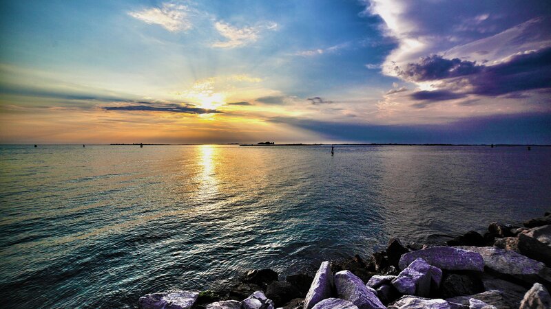 Sunset over Calm Water — Blue, Serene, Photograph, Rocks, Clouds, Sun
