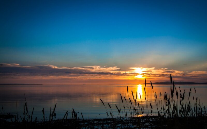 Sunset over Calm Water — Blue, Serene, Photograph, Sky, Grass