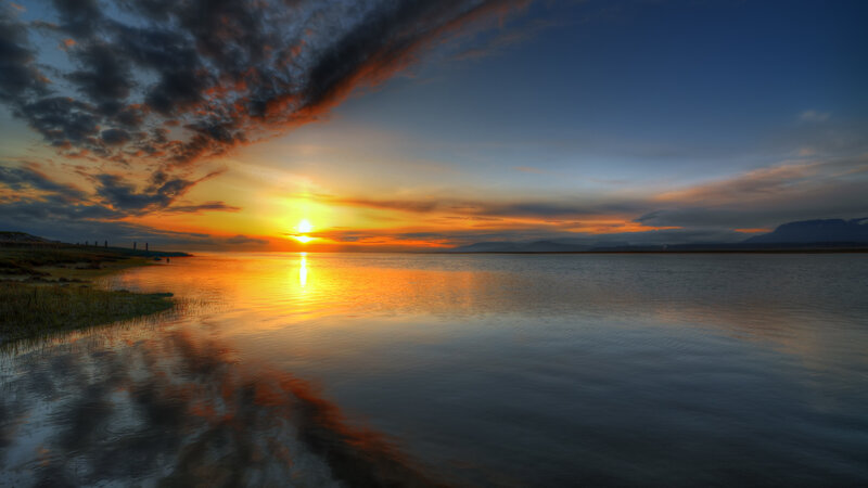 Sunset over Calm Water — Orange, Serene, Photograph, Clouds, Mountains