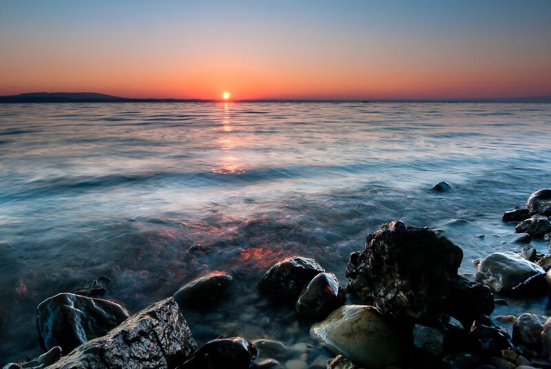 Sunset over Calm Water — Orange, Serene, Photograph, Rocks