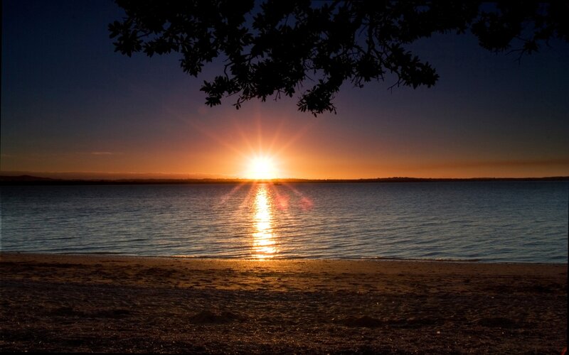 Sunset over Calm Water — Orange, Serene, Photograph, Tree Branches