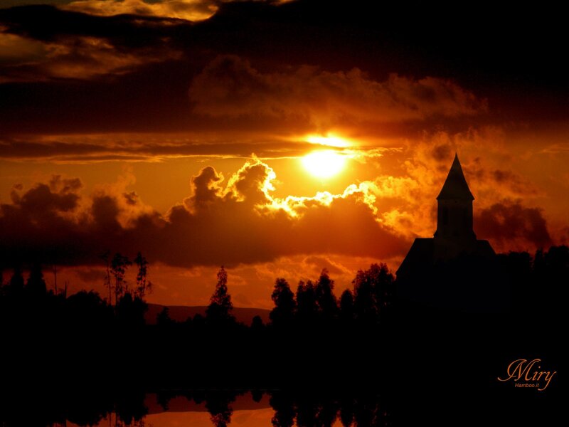 Sunset over church silhouette